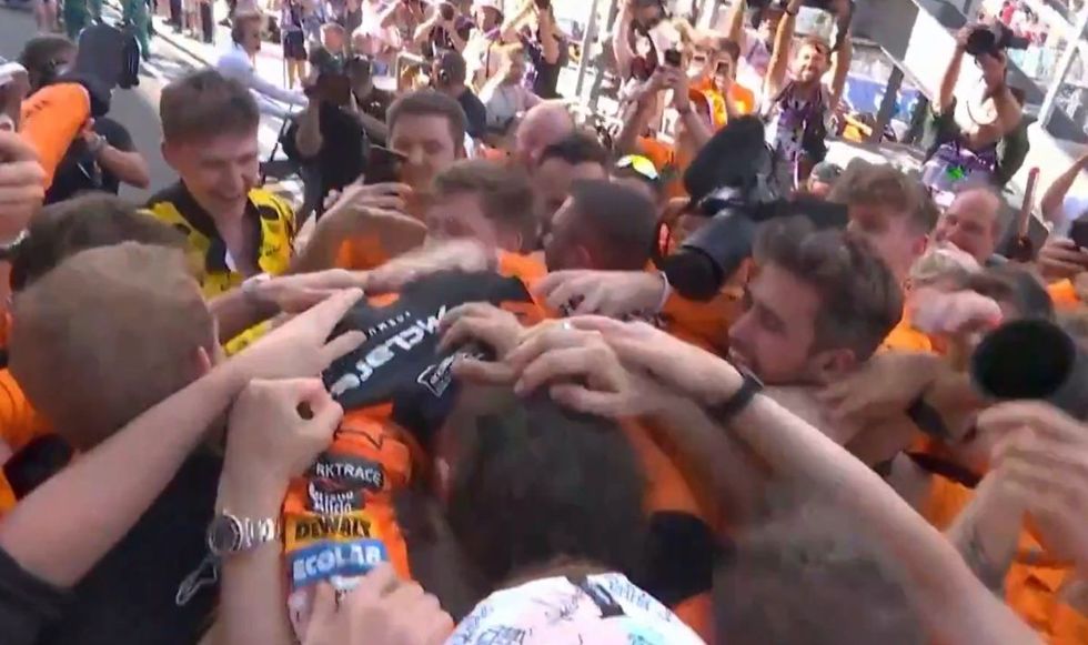 Lando Norris celebrated the win by jumping on his team