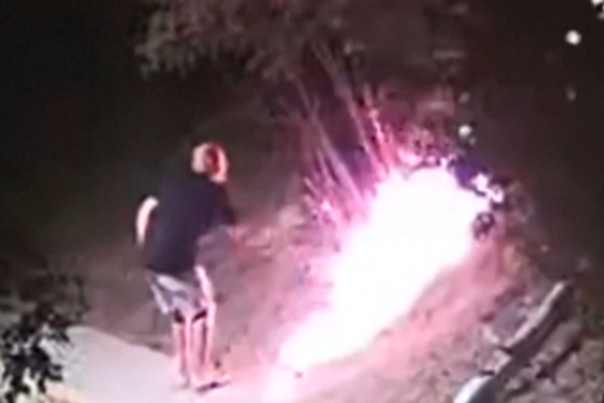 Later in the footage, the suspect can be seen batting down the fire as it rages
