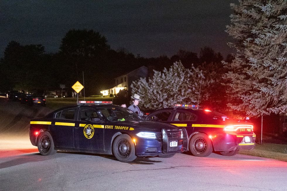 Law enforcement personnel are seen at the home of Buffalo supermarket shooting suspect Payton Gendron in Conklin, New York.