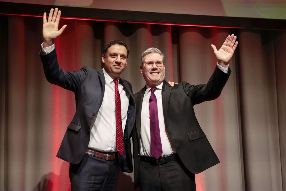Leader of the Labour Party Sir Keir Starmer (R) stands on stage with Anas Sarwar leader of Scottish Labour (L)