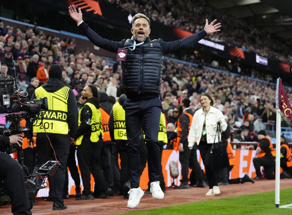 Lee Hendrie found himself restrained by security staff after goading Nottingham Forest supporters during Aston Villa's emphatic Europa League semi-final second leg triumph on Thursday evening