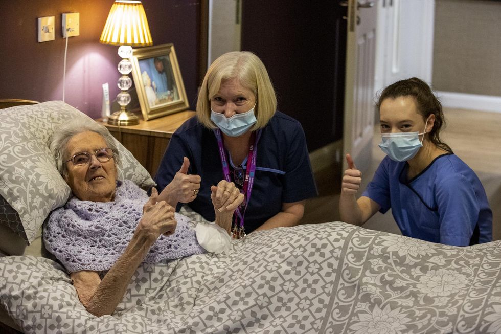 (Left to right) 100-year-old Ethel Sinclair, with care staff Cathy Lacey and Lauren Adams, who was among residents to receive the coronavirus vaccine at Bradley Manor care home in north Belfast.