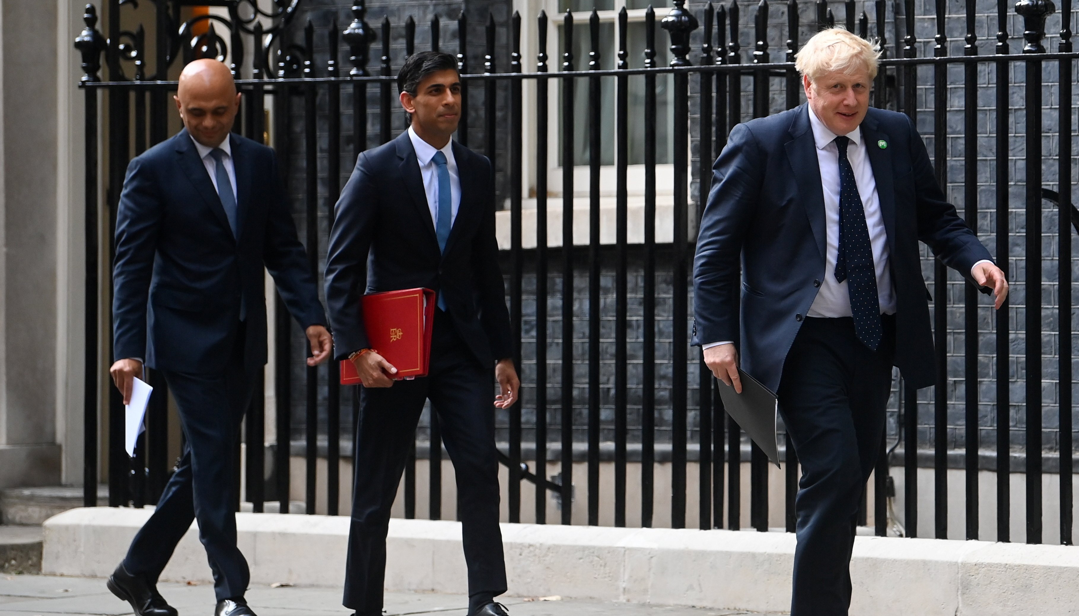 (left to right) Health Secretary Sajid Javid, Chancellor of the Exchequer Rishi Sunak and Prime Minister Boris Johnson arriving at No.9 Downing Street.