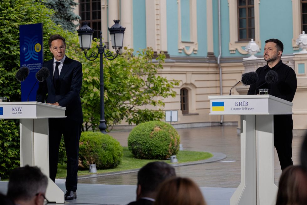 (left to right) Mark Rutte and Volodymyr Zelensky, standing behind podiums