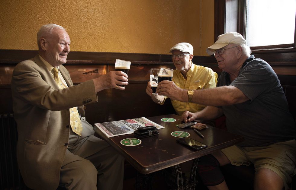 (left to right) Peter Roche, from Finglas, Dublin enjoys a pint with his friends Jack Edwards, from Florida, Archie Rutledge, from Texas in Mulligans Bar on Poolbeg Street in Dublin as indoor dining in pubs and restaurants have reopened across Ireland, marking a significant step for the hospitality sector. Picture date: Monday July 26, 2021.