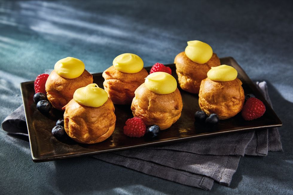 Lemon profiteroles, with lemon icing and raspberries and blueberries