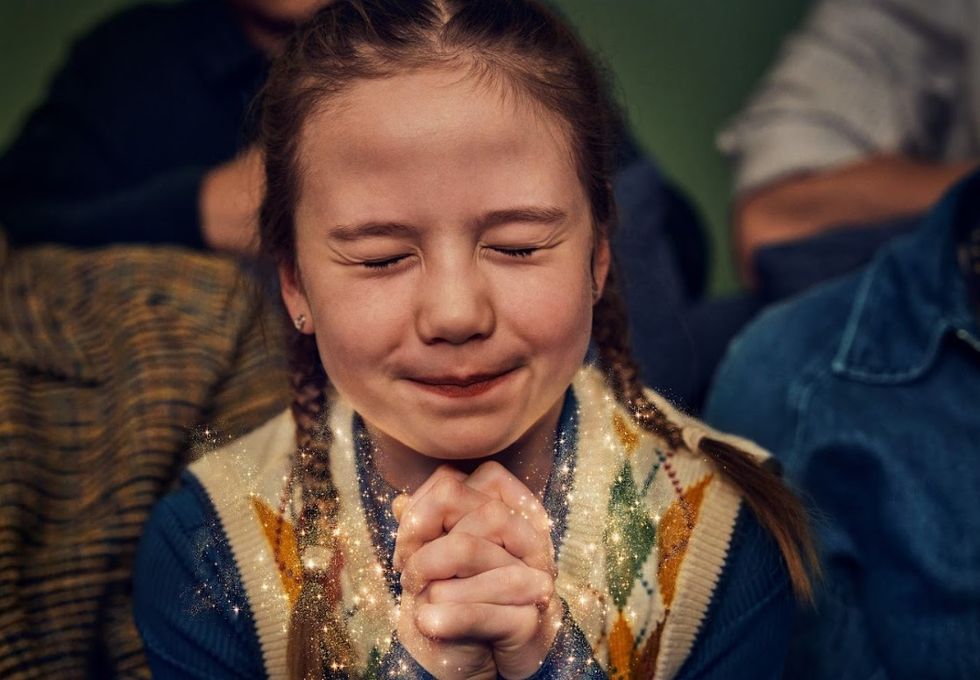 Little girl making a Christmas wish
