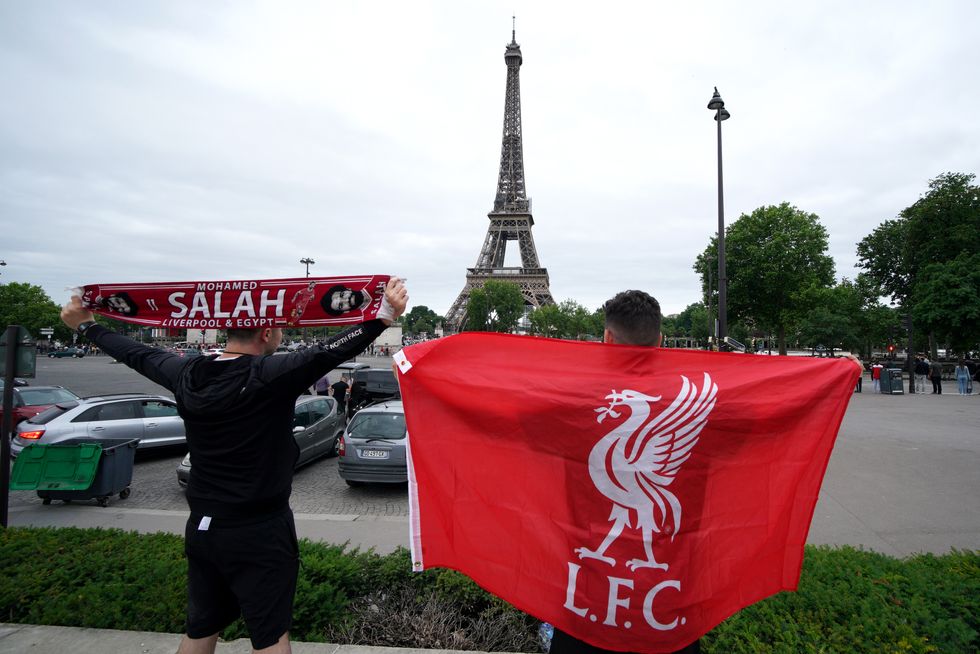Liverpool fans pose for a photo in front of the Eiffel Tower in Paris ahead of Saturday's UEFA Champions League Final at the Stade de France, Paris. Picture date: Thursday May 26, 2022.