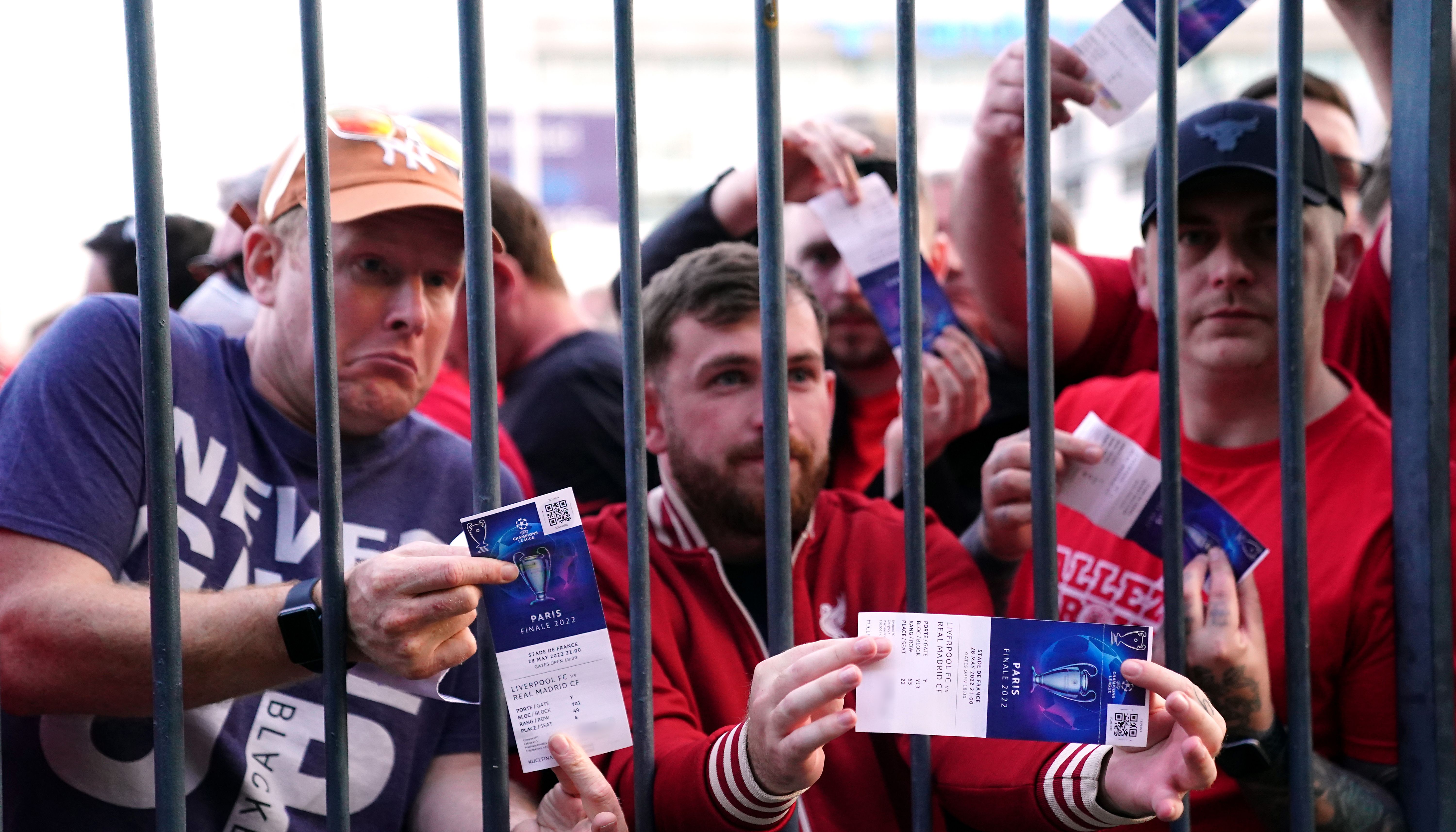 Liverpool fans stuck outside the ground show their match tickets during the UEFA Champions League Final at the Stade de France, Paris. Picture date: Saturday May 28, 2022.