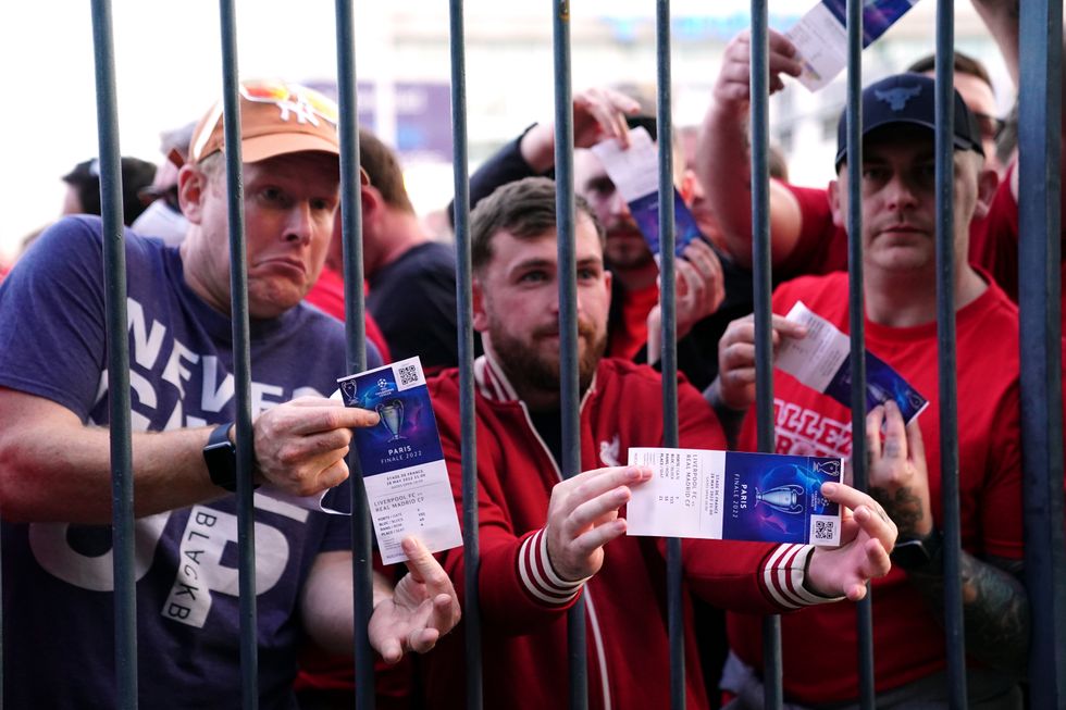 Liverpool fans stuck outside the ground show their match tickets during the UEFA Champions League Final at the Stade de France, Paris. Picture date: Saturday May 28, 2022.
