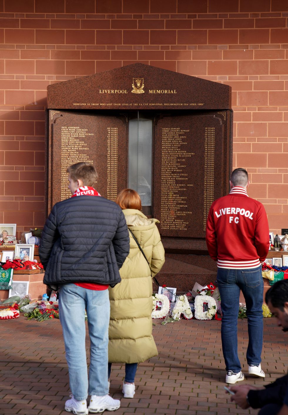 Liverpool fans visit the Hillsborough Memorial at Anfield