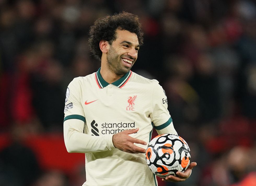 Liverpool hat-trick scorer Mohamed Salah celebrates with the match ball after the final whistle during the Premier League match at Old Trafford