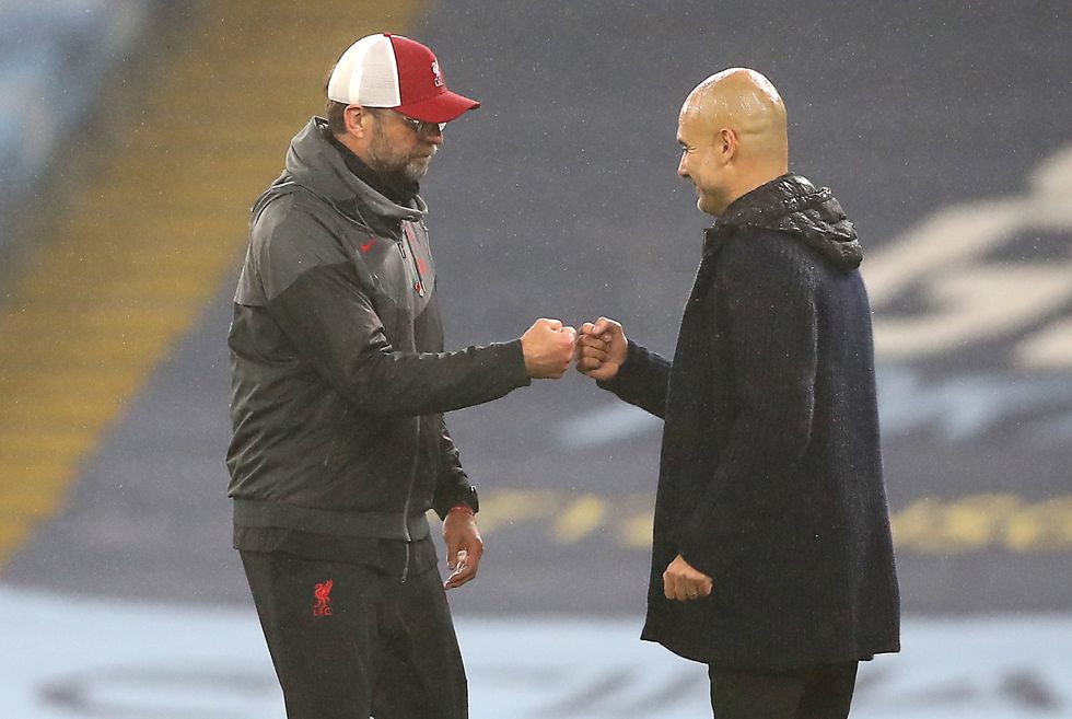 Liverpool manager Jurgen Klopp (left) and Manchester City manager Pep Guardiola after the final whistle during the Premier League match at the Etihad Stadium, Manchester.