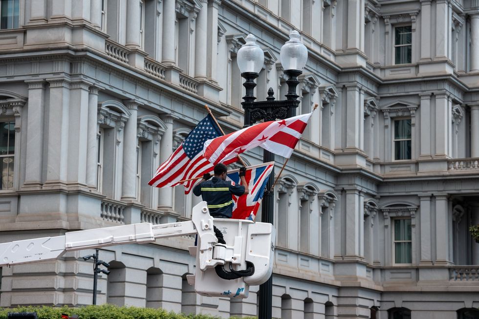 Local DC government workers replace the Australian flag with the Union Jack