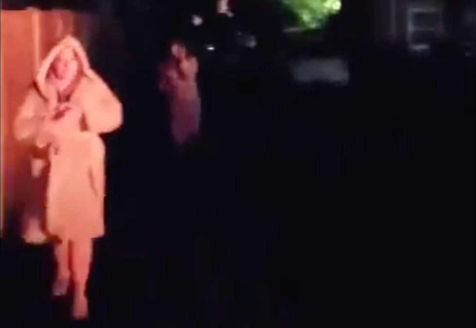 Local in her dressing gown looking at the car fires