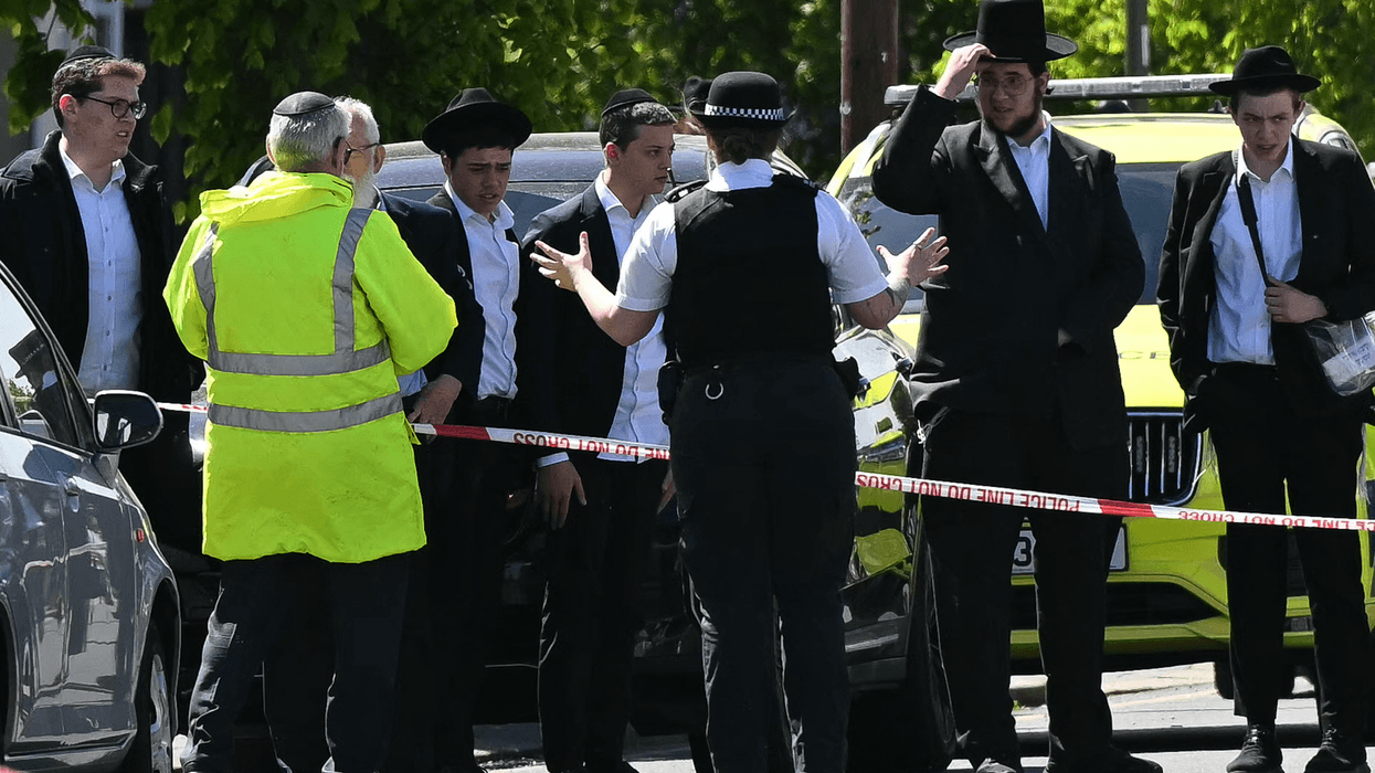 Local residents look on from outside a cordoned off area in the Golders Green neighbourhood of north London on April 29, 2026, following the stabbing to two people nearby.