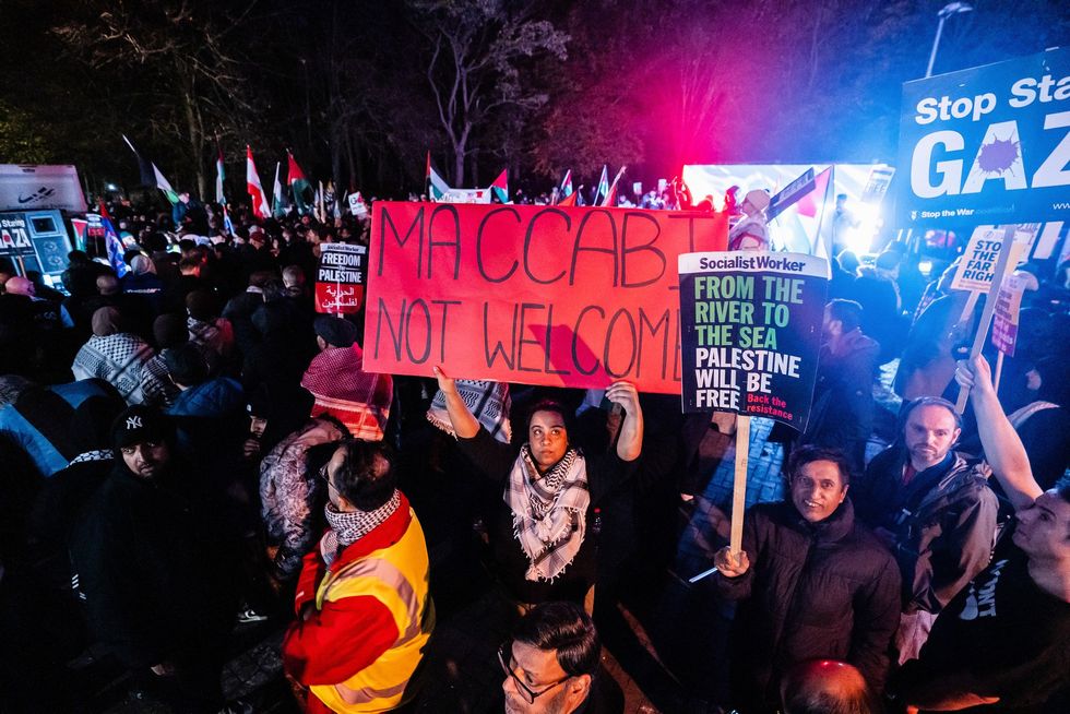 Locals stood around the protest with banners saying, 'Maccabi not welcome'