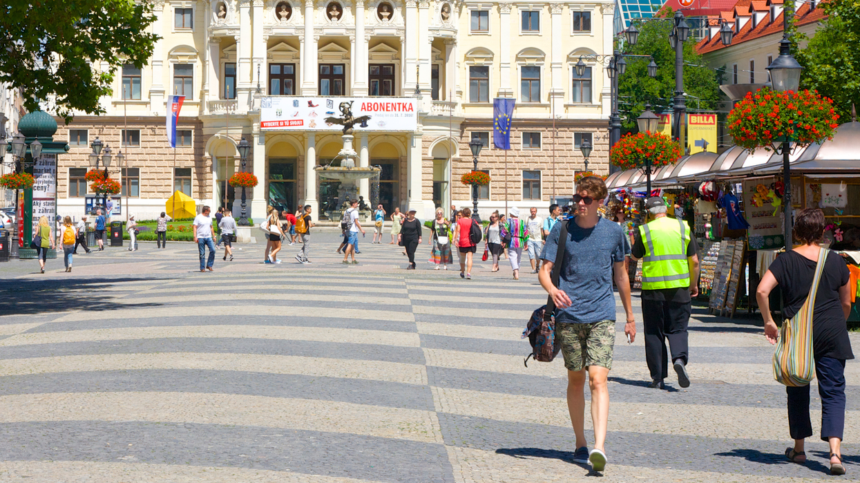 Locals walk through Hviezdoslav Square in Slovak capital Bratislava's old town