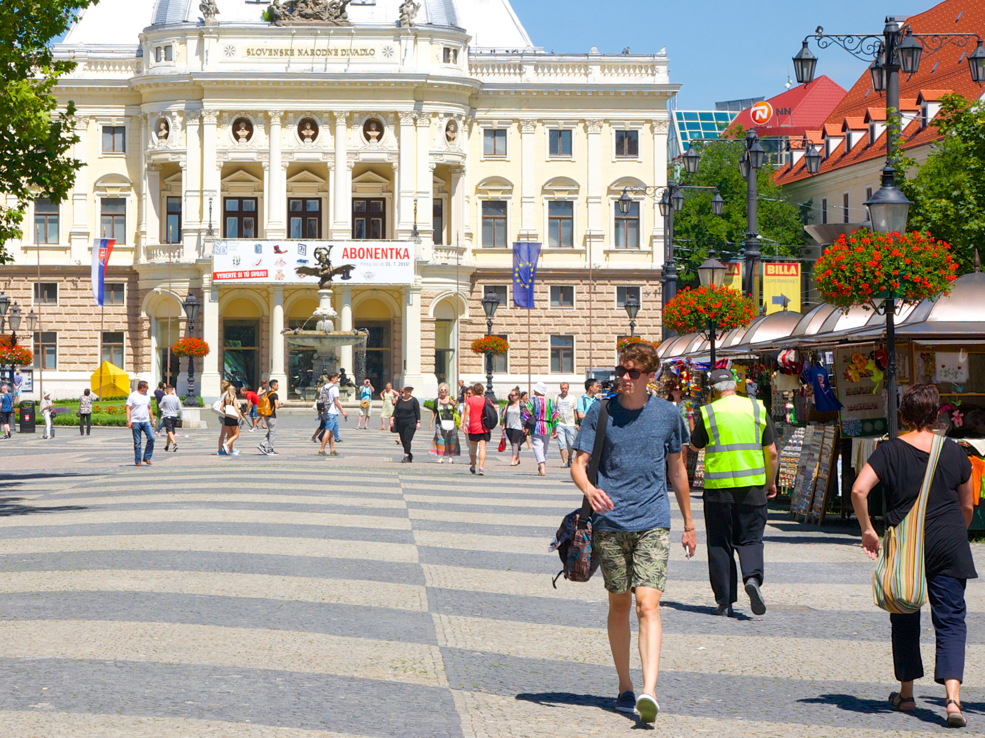 Locals walk through Hviezdoslav Square in Slovak capital Bratislava's old town