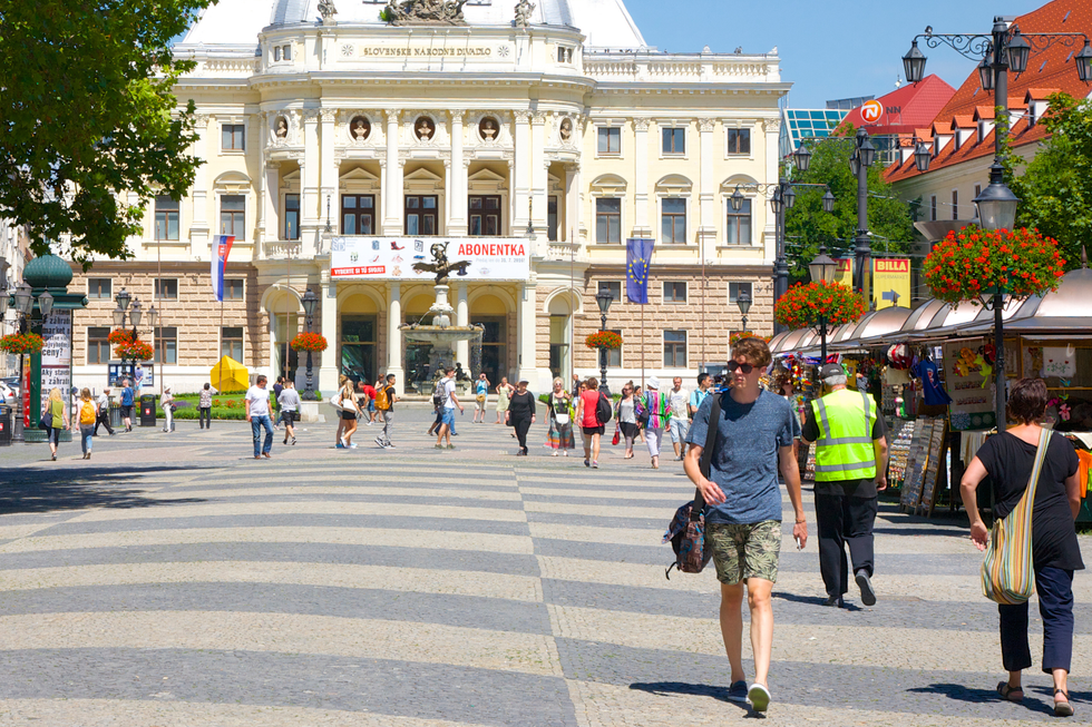 Locals walk through Hviezdoslav Square in Slovak capital Bratislava's old town