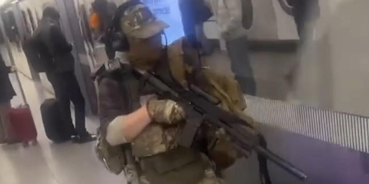 NextImg:Terrifying moment camo-clad man aims 'assault rifle' at London Underground train