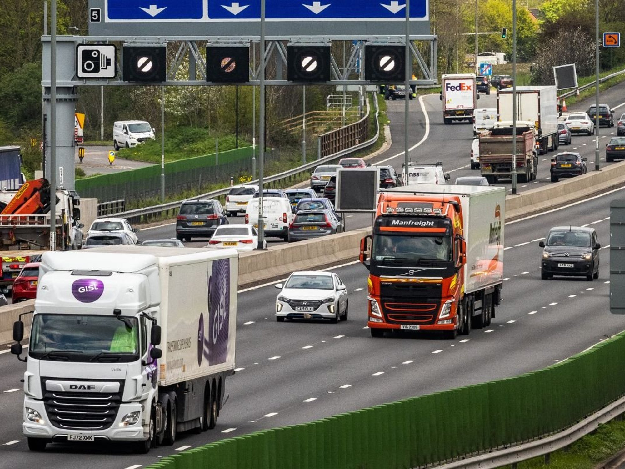 Lorries driving on a motorway near London