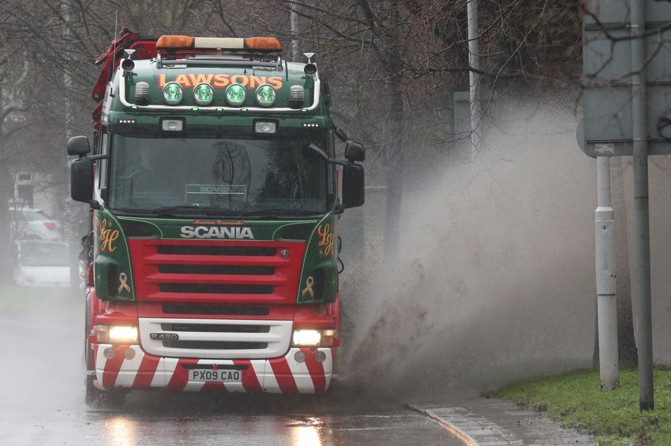 Lorry driving through a large puddle