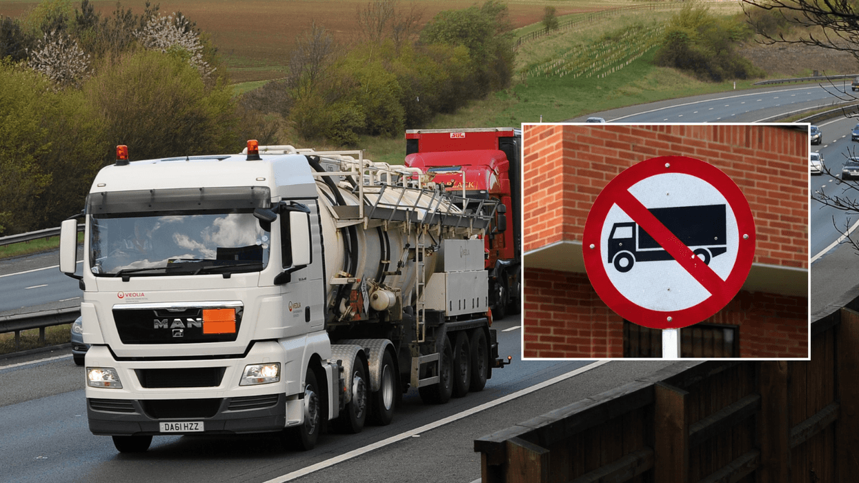 Lorry on the road and HGV ban sign
