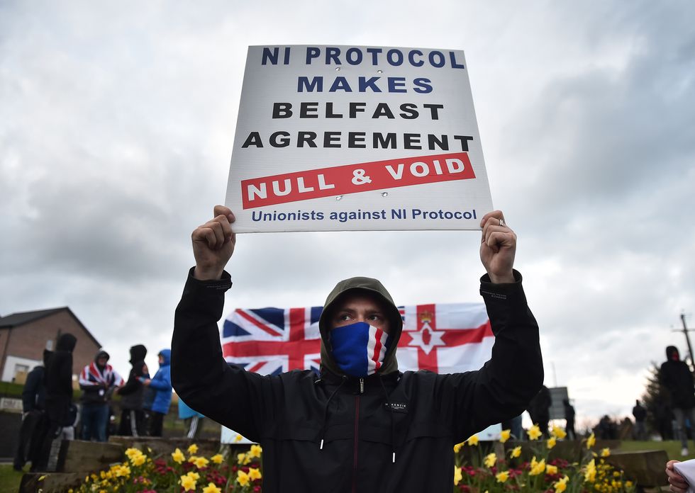 Loyalists hold up placards during an anti Northern Ireland Protocol protest against the so called Irish Sea border