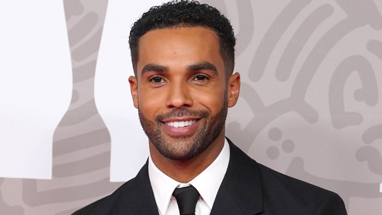 Lucien Laviscount smiling on the red carpet