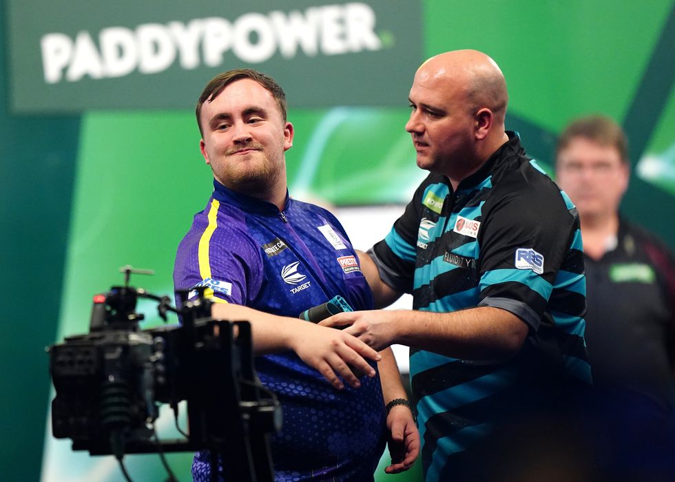 Luke Littler was congratulated by Rob Cross