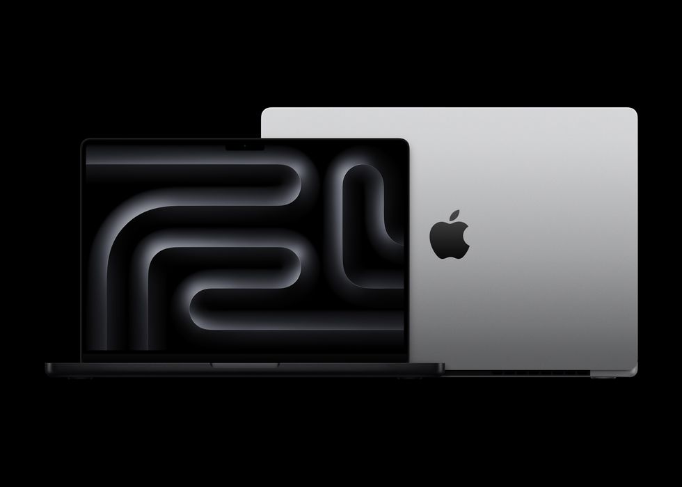 macbook pro in space black and silver on a dark black background