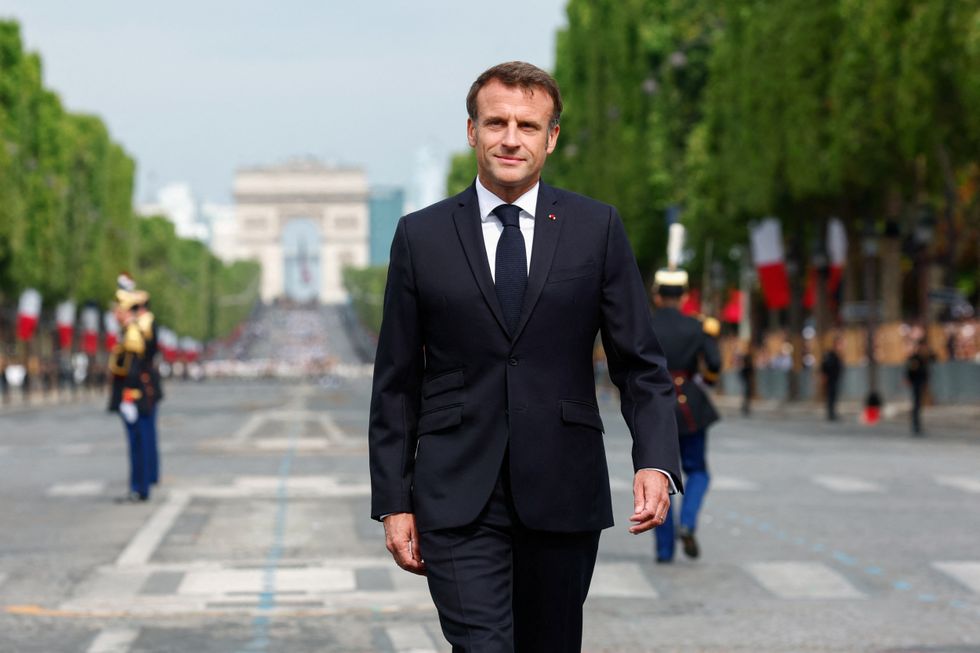 Macron reviews the troops during the annual Bastille Day military parade on the Champs-Elysees avenue in Paris, France, on July 14.