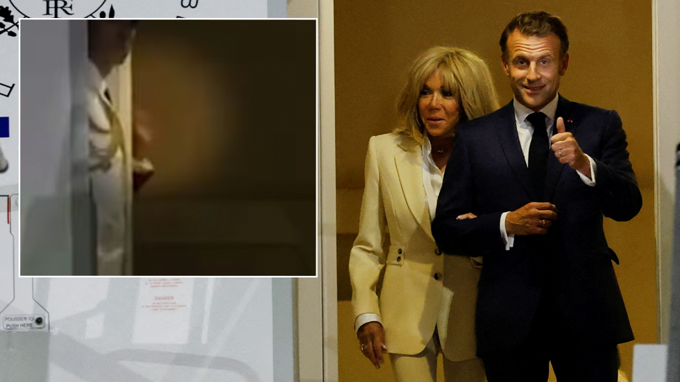 Macron waves to the media from behind a plane door