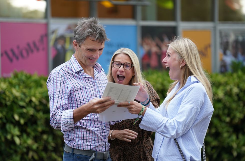 Maddie Hallam with her parents receiving her GCSE results at Norwich School, in Norwich, Norfolk
