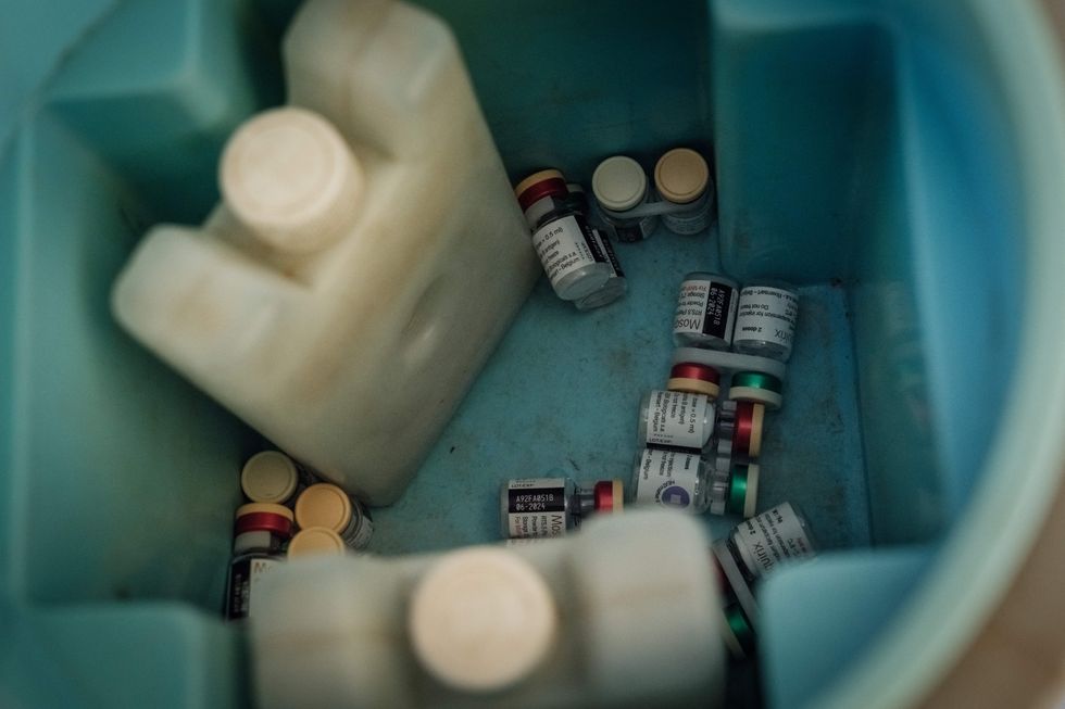 Malaria vaccine containers are stored in a cooler box