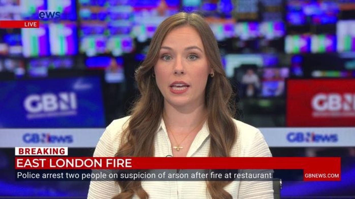 Man and boy, 15, arrested on suspicion of arson after huge fire leaves two in life-threatening condition