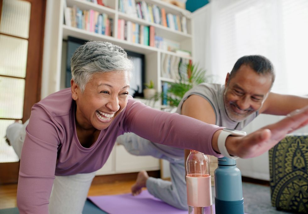 Man and woman doing yoga at home
