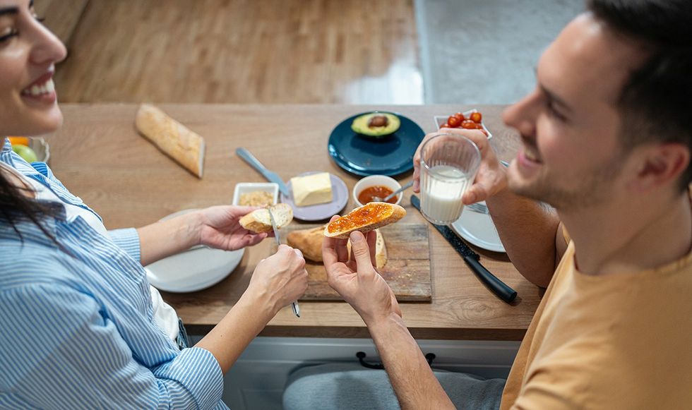 Man and woman eating breakfast together
