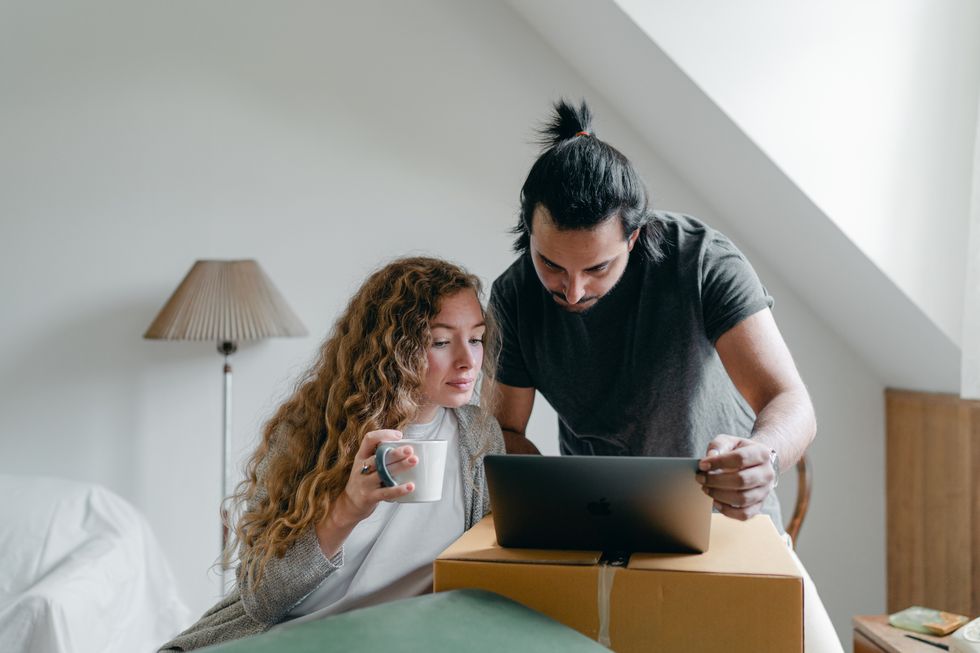 Man and woman looking at a laptop screen