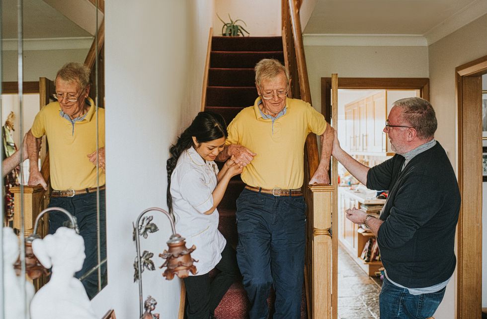 Man being helped down staircase