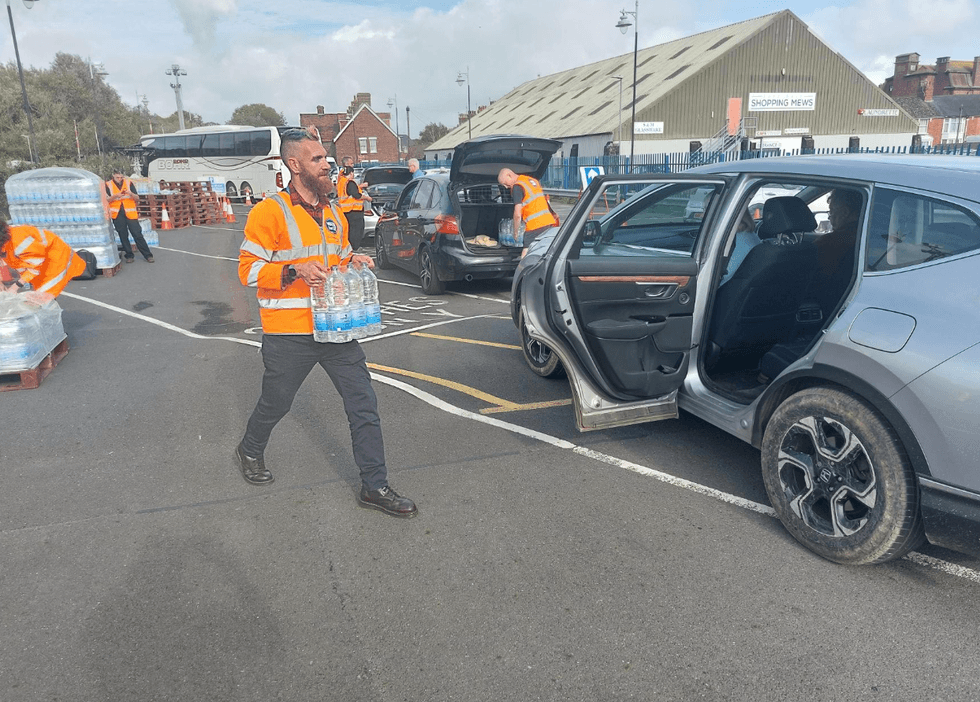 Man carrying bottles of water