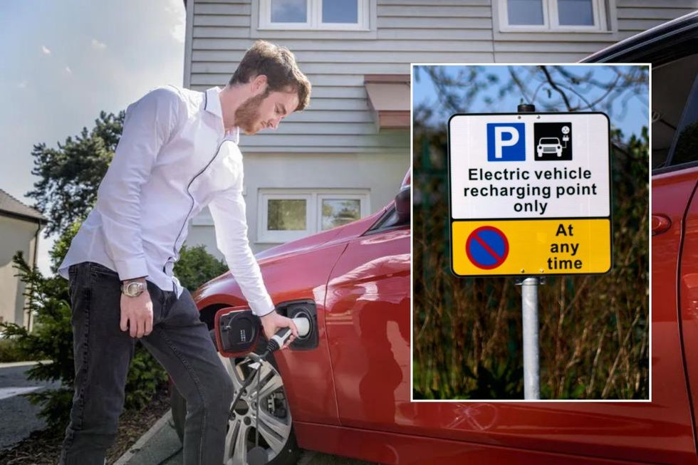 Man charging an electric car and an electric car charging sign