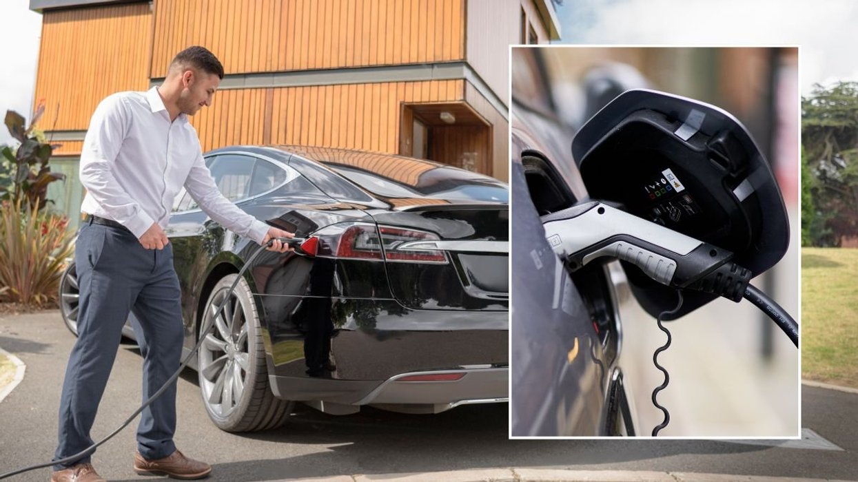 Man charging an electric car at home and an EV charger