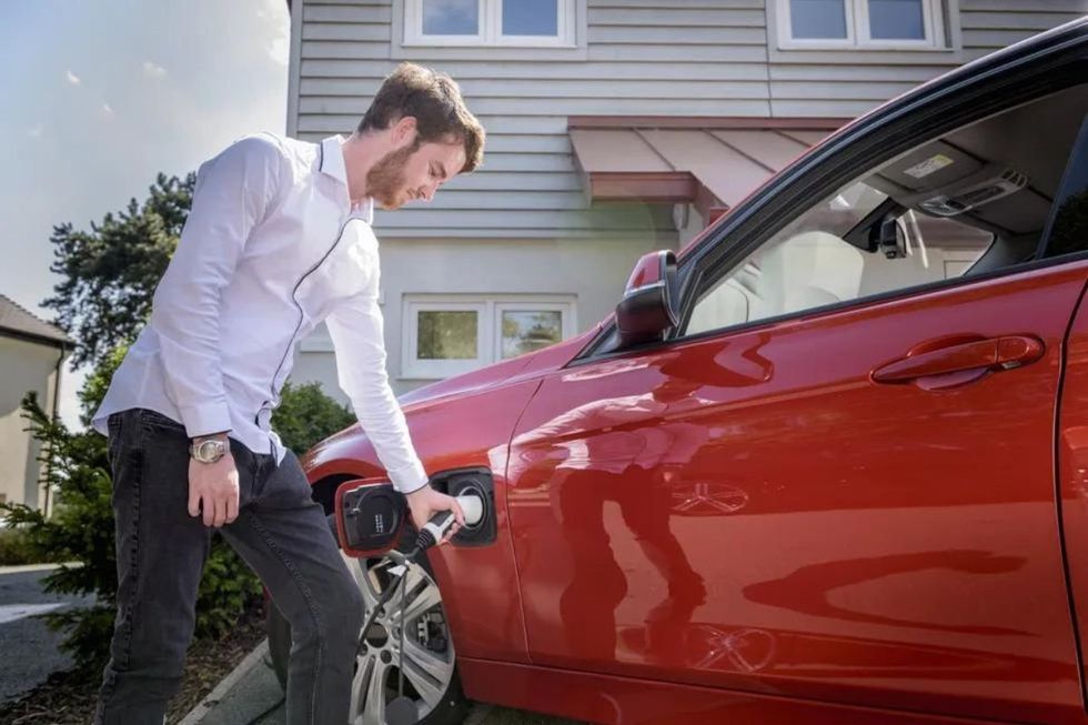 Man charging an electric car