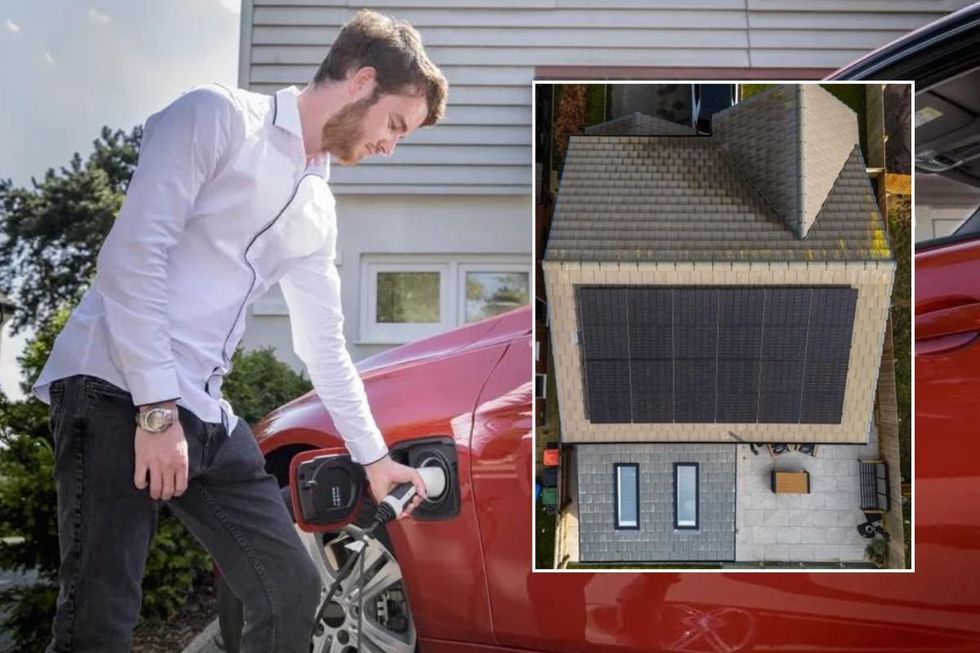 Man charging electric car at home and a house covered in solar panels