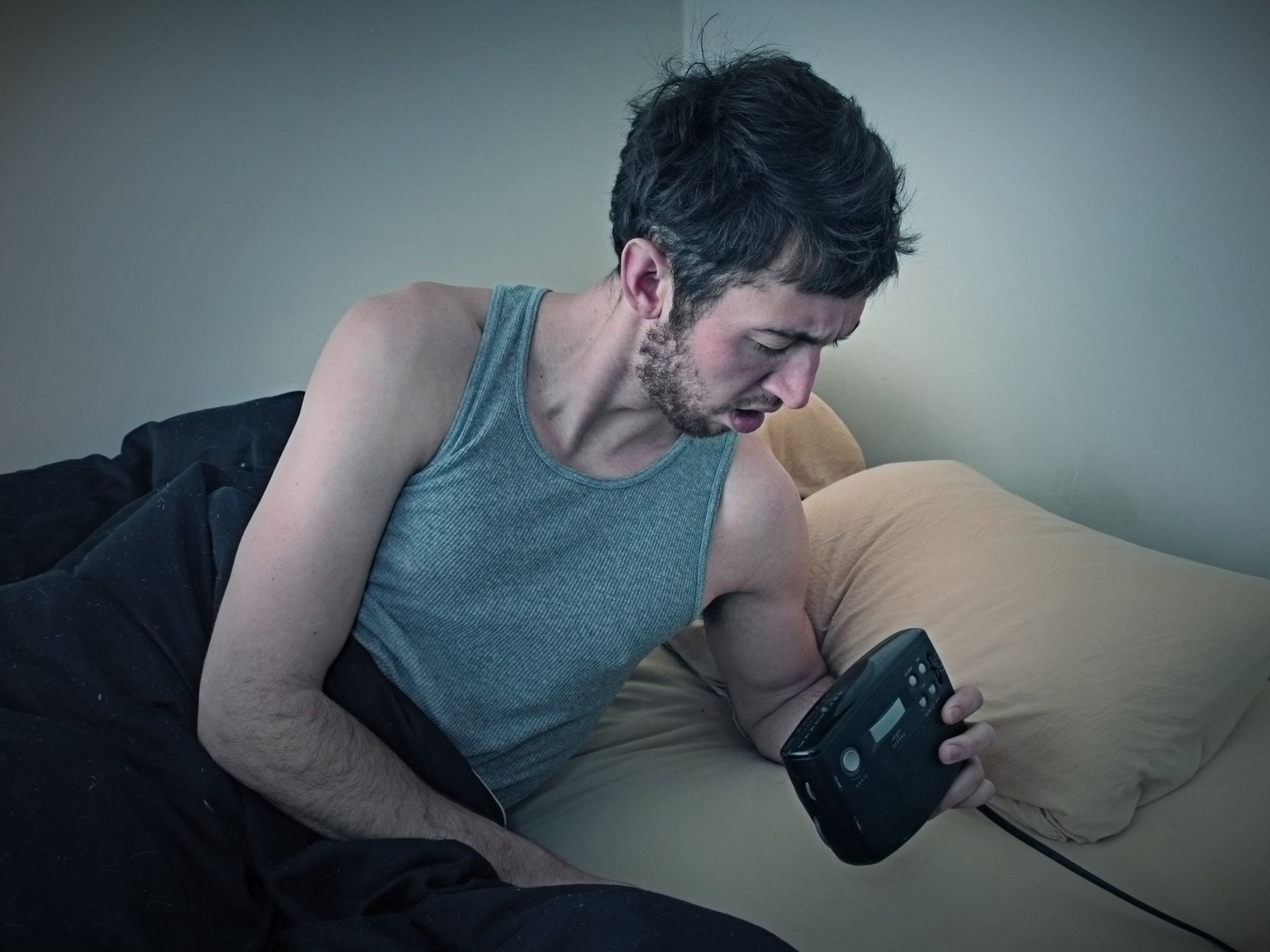 Man checking his alarm in the early hours of the morning