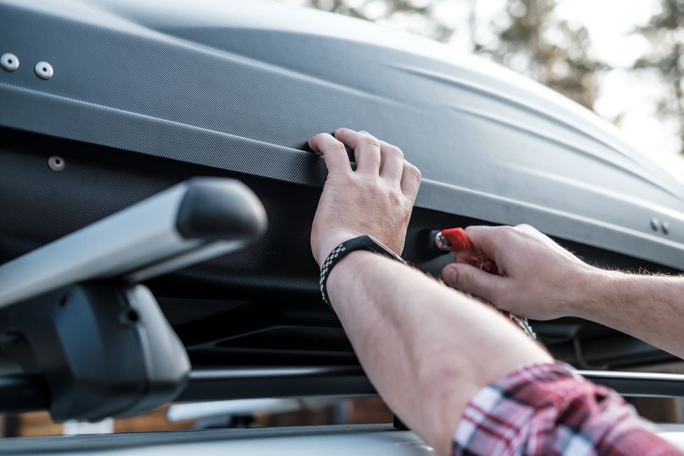 Man checking safety of roofbox