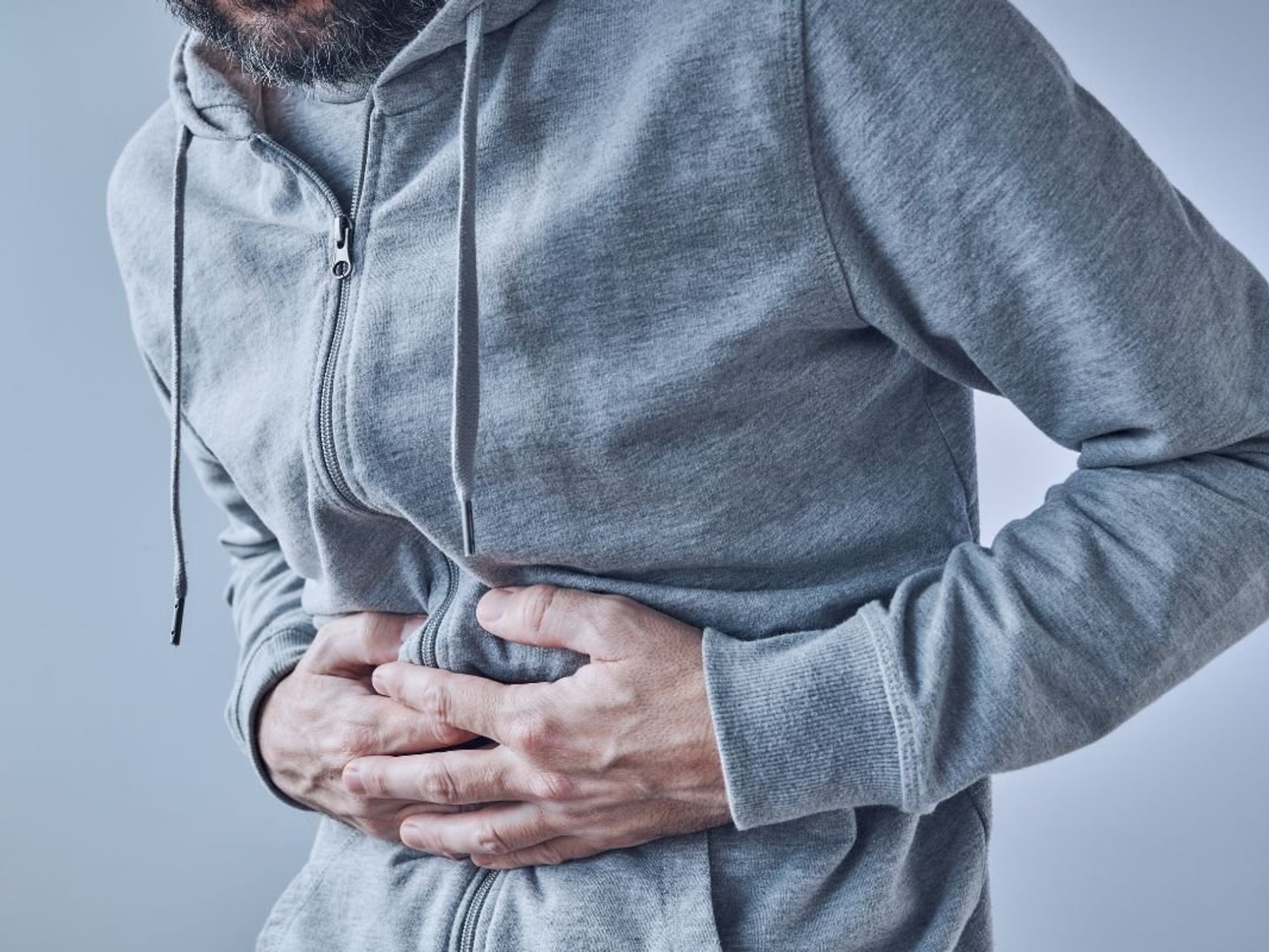 Man clutching stomach