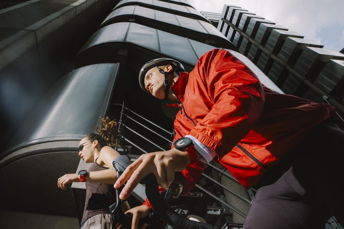man cycling next to a woman running with the Watch 3 Pro from CMF by Nothing on both of their wrists